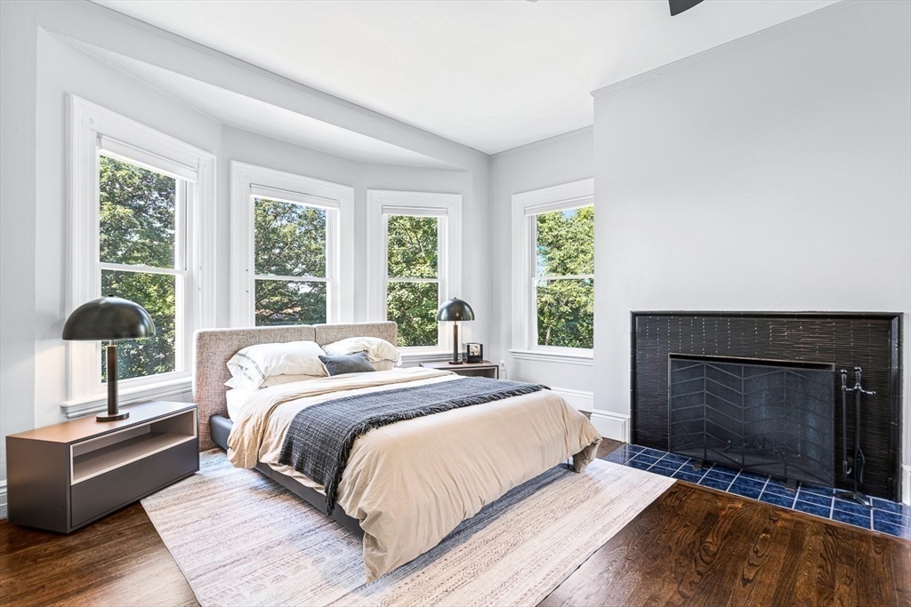 5 Babson Street, Unit 2 Gloucester, MA 01930 - Photo 9 of 23 a bed sitting in a bedroom next to a window