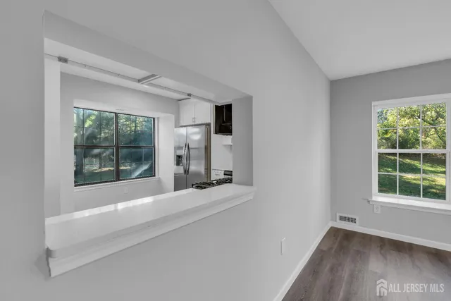 a bathroom with a bathtub and windows