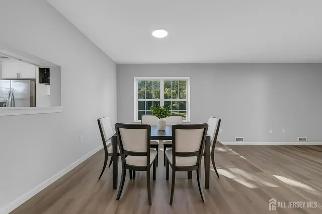 a view of a dining room with furniture and window