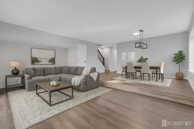 a living room with furniture and wooden floor