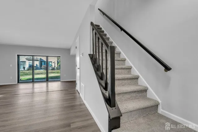 a view of an entryway with wooden floor