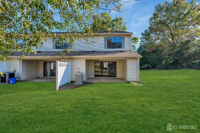 a view of a house with a yard and deck