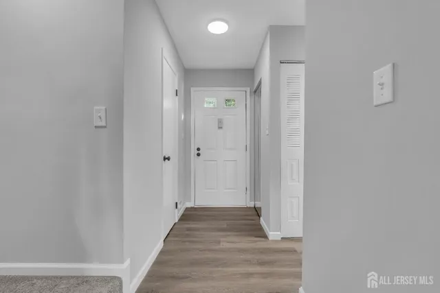 a view of a hallway with wooden floor