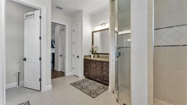 a bathroom with a granite countertop sink a toilet and shower