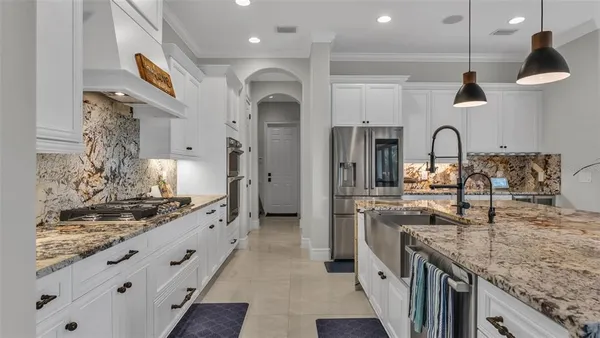 a kitchen with a refrigerator and a sink