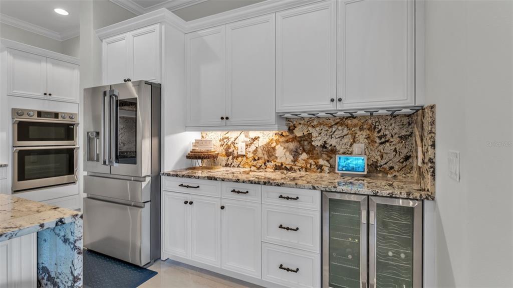 6538 Eagle View Loop Lakeland, FL 33813 - Photo 42 of 89 a kitchen with stainless steel appliances granite countertop a refrigerator and a stove