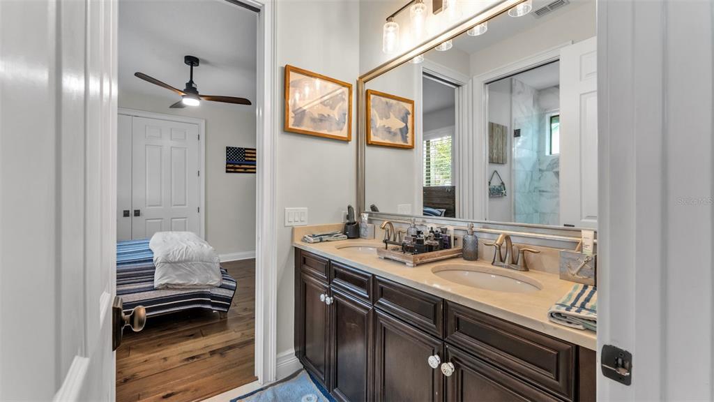 6538 Eagle View Loop Lakeland, FL 33813 - Photo 54 of 89 a en suite bathroom with a sink and a mirror