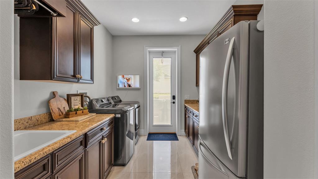 6538 Eagle View Loop Lakeland, FL 33813 - Photo 71 of 89 a kitchen with a refrigerator and a sink