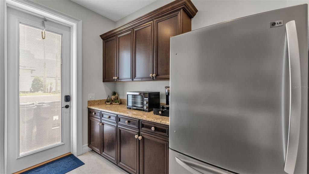 6538 Eagle View Loop Lakeland, FL 33813 - Photo 73 of 89 a kitchen with stainless steel appliances granite countertop a refrigerator and a sink