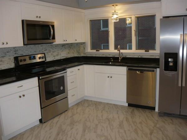 30 Pitman Road Swampscott, MA 01907 - Photo 14 of 31 a kitchen with stainless steel appliances granite countertop a stove a sink and a microwave