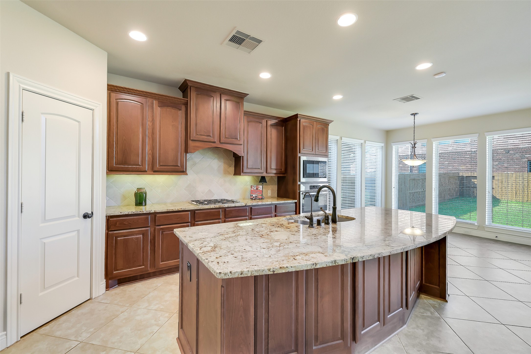 27906 Colonial Point Drive Katy, TX 77494 - Photo 10 of 39 a kitchen with kitchen island granite countertop a sink and refrigerator