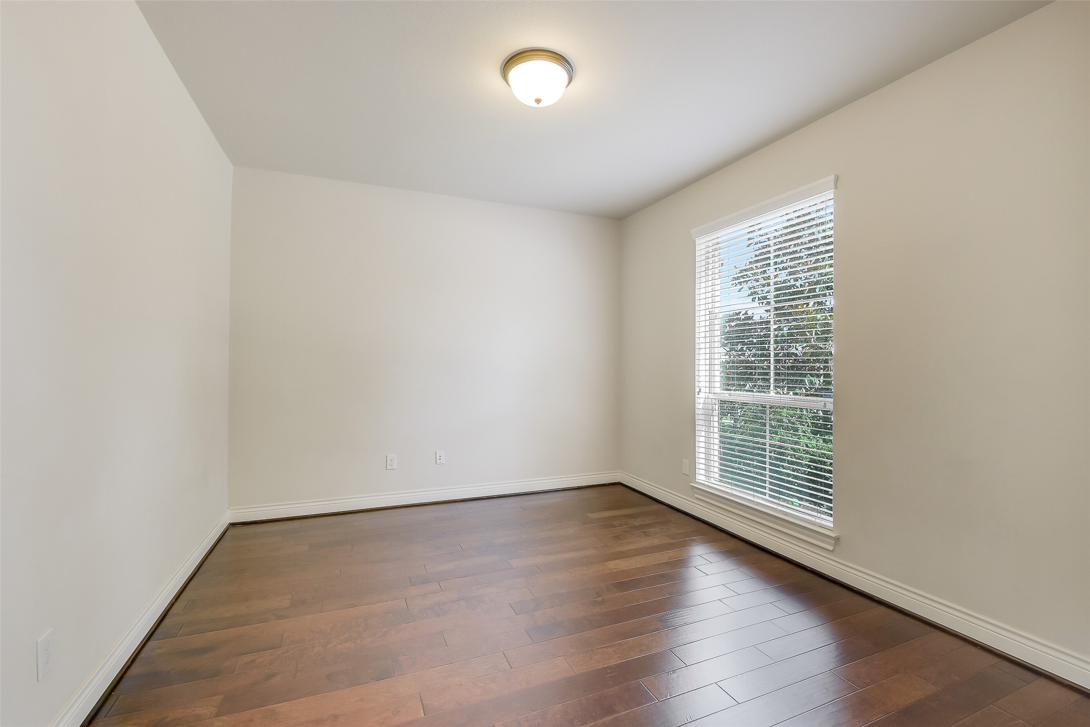 27906 Colonial Point Drive Katy, TX 77494 - Photo 15 of 39 an empty room with wooden floor and windows
