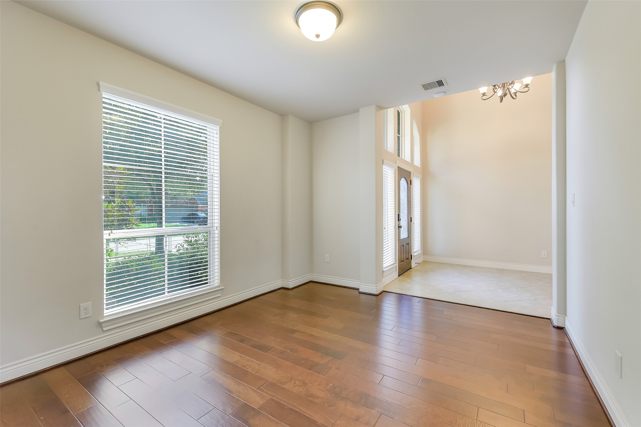27906 Colonial Point Drive Katy, TX 77494 - Photo 16 of 39 a view of an empty room with wooden floor and a window
