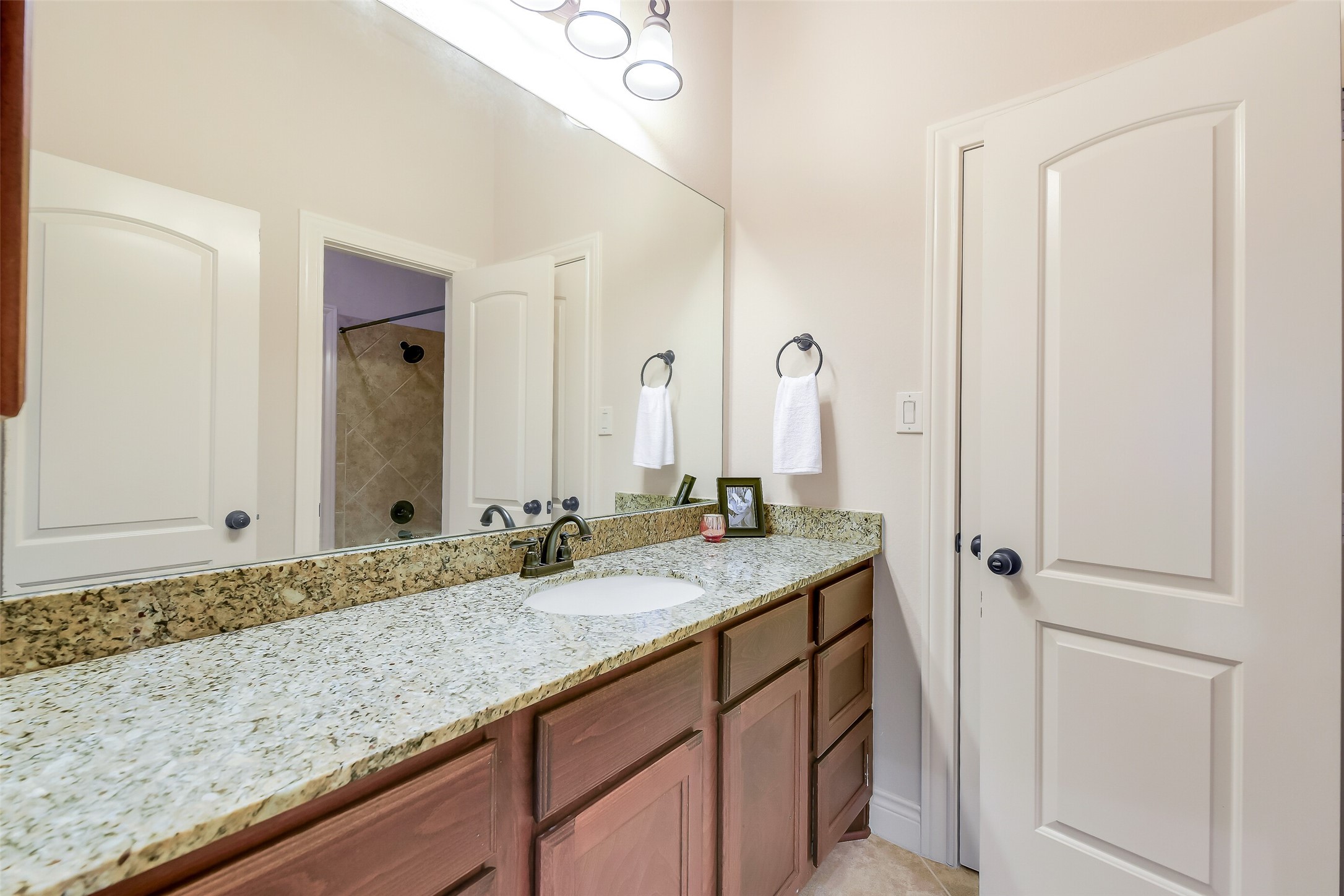 27906 Colonial Point Drive Katy, TX 77494 - Photo 32 of 39 a bathroom with a granite countertop sink and a mirror