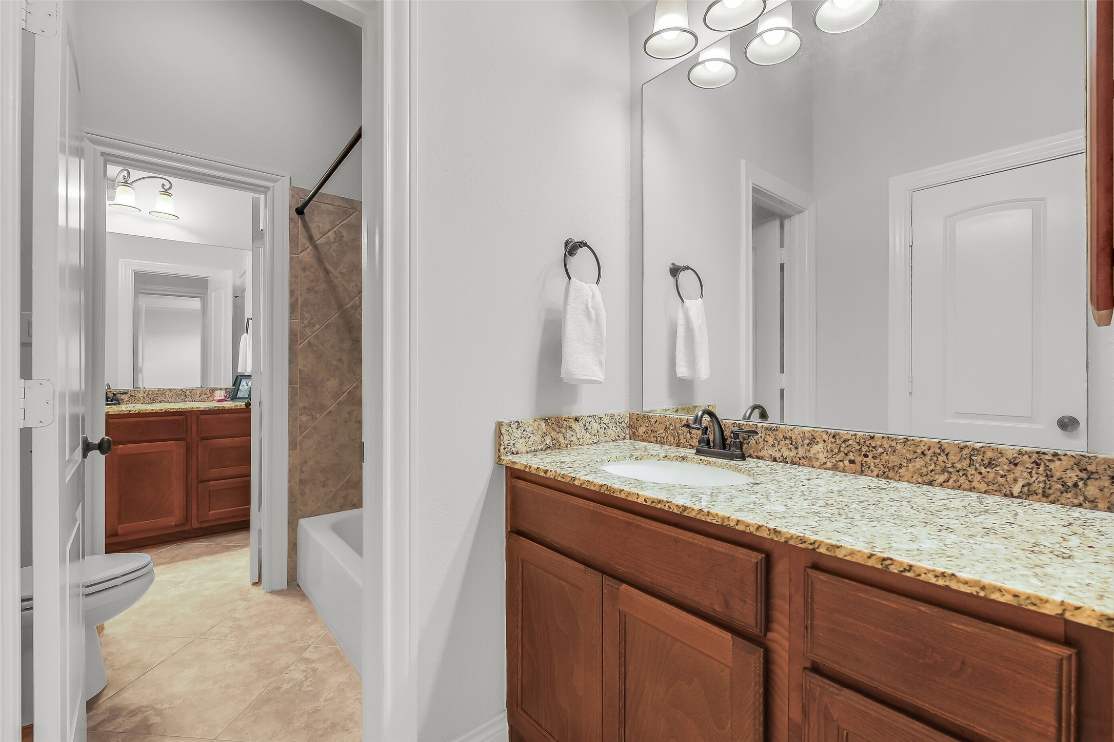 27906 Colonial Point Drive Katy, TX 77494 - Photo 34 of 39 a bathroom with a granite countertop sink and a mirror