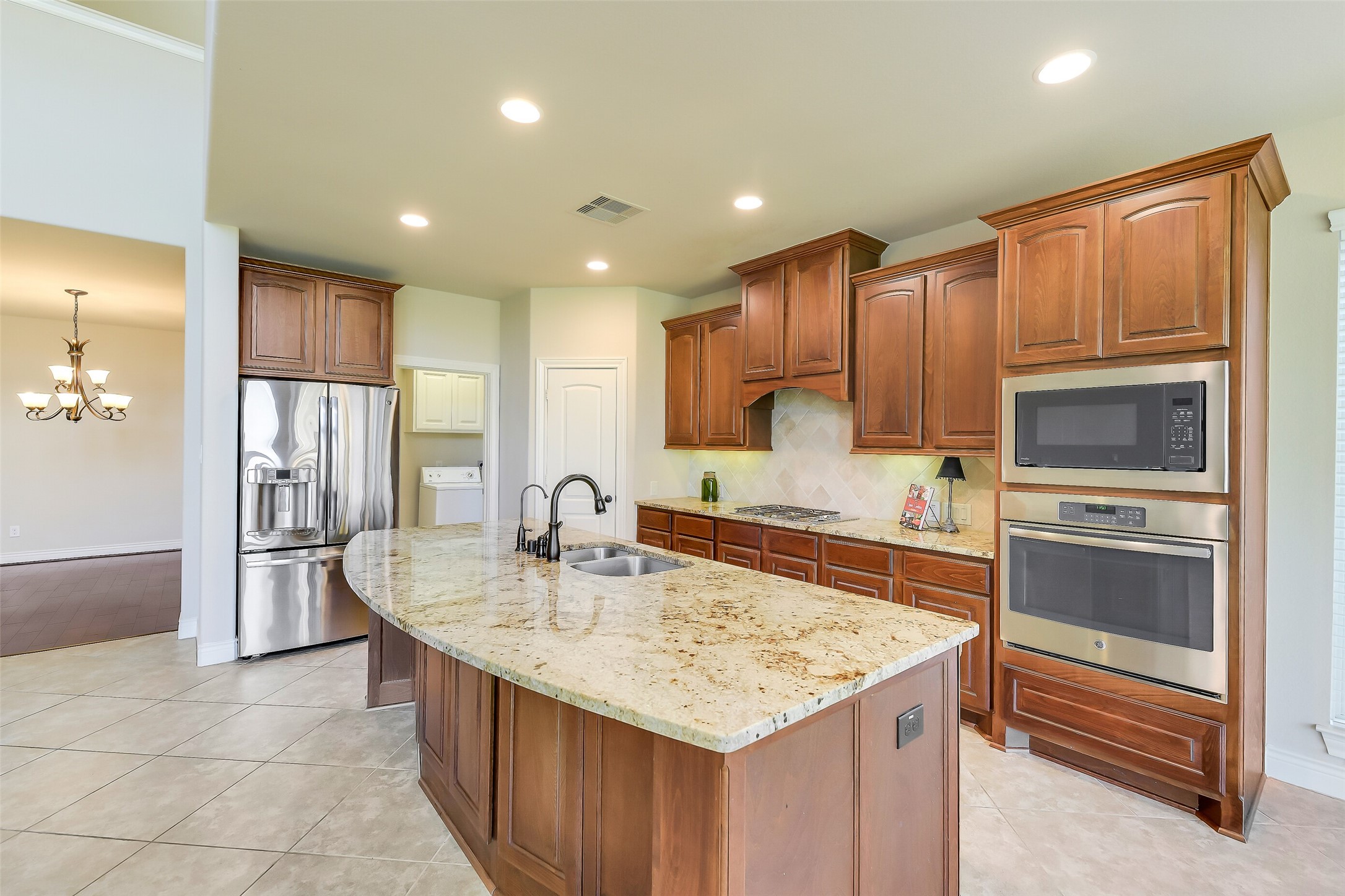 27906 Colonial Point Drive Katy, TX 77494 - Photo 7 of 39 a kitchen with kitchen island granite countertop a sink stove and refrigerator