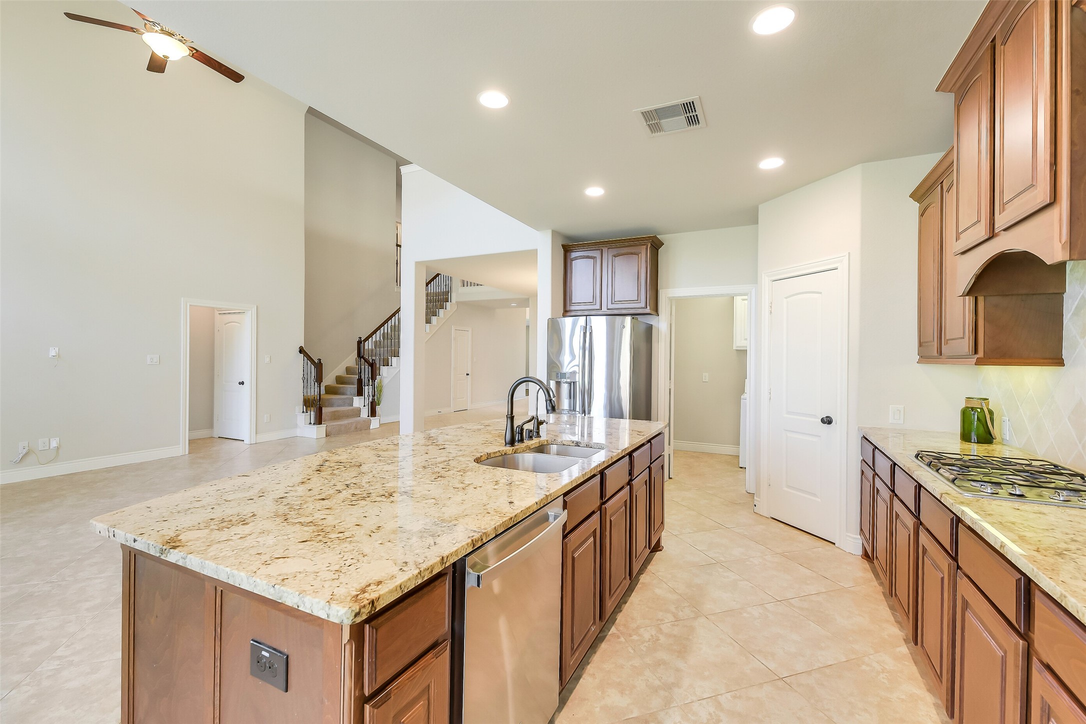 27906 Colonial Point Drive Katy, TX 77494 - Photo 8 of 39 a kitchen with kitchen island a sink stove and refrigerator