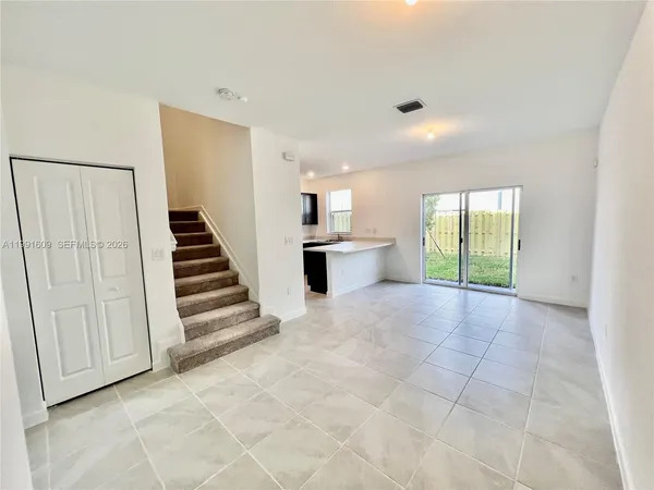a view of a kitchen with wooden floor and stairs