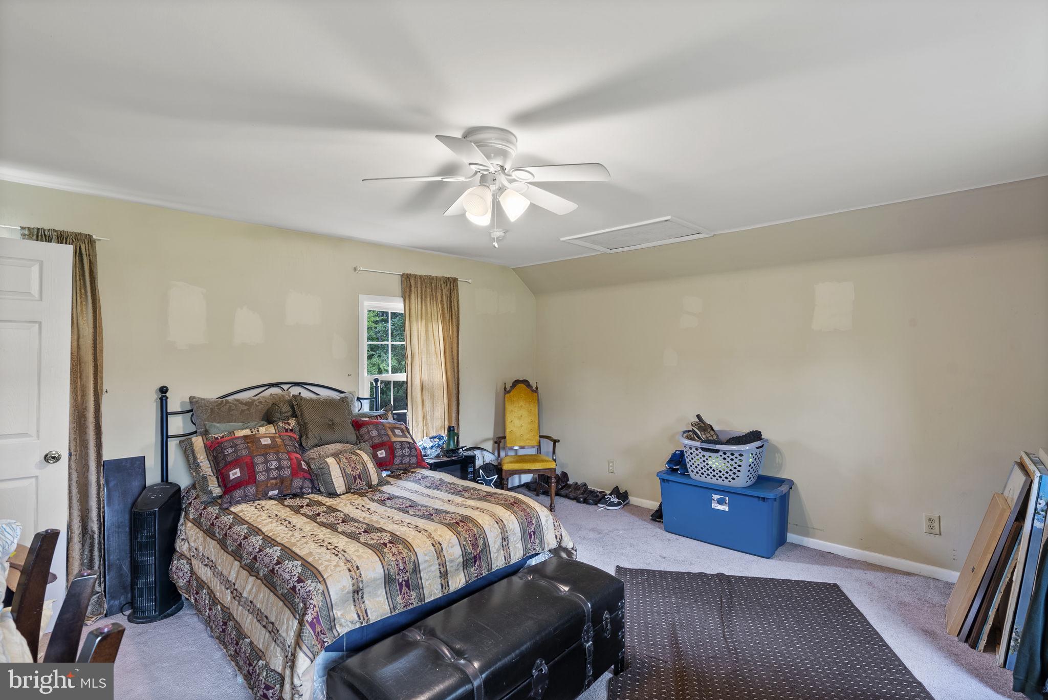 12625 Harford Road Kingsville, MD 21087 - Photo 18 of 33 a bedroom with a bed a couch and wooden floor