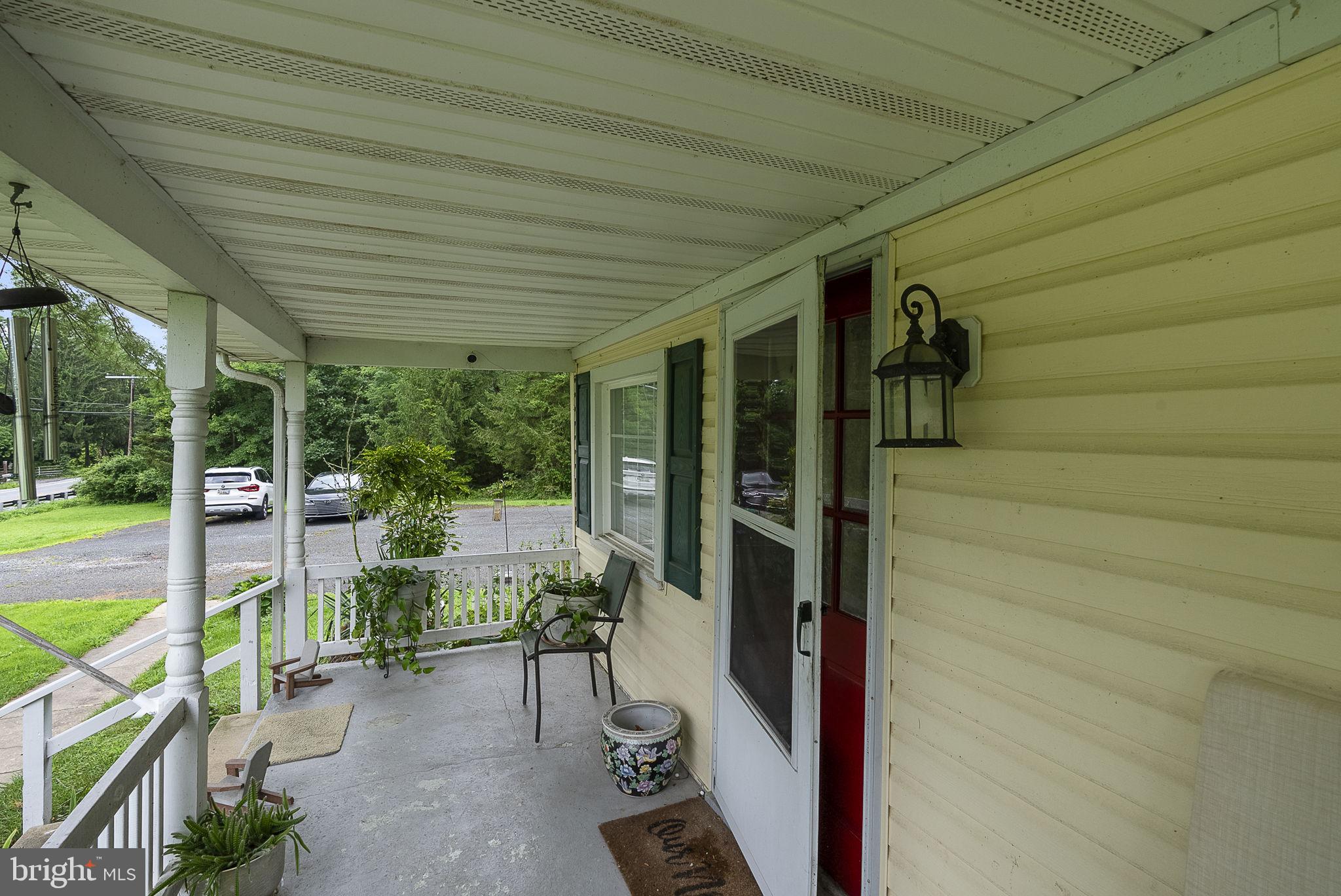 12625 Harford Road Kingsville, MD 21087 - Photo 25 of 33 a view of a patio with table and chairs and floor to ceiling window