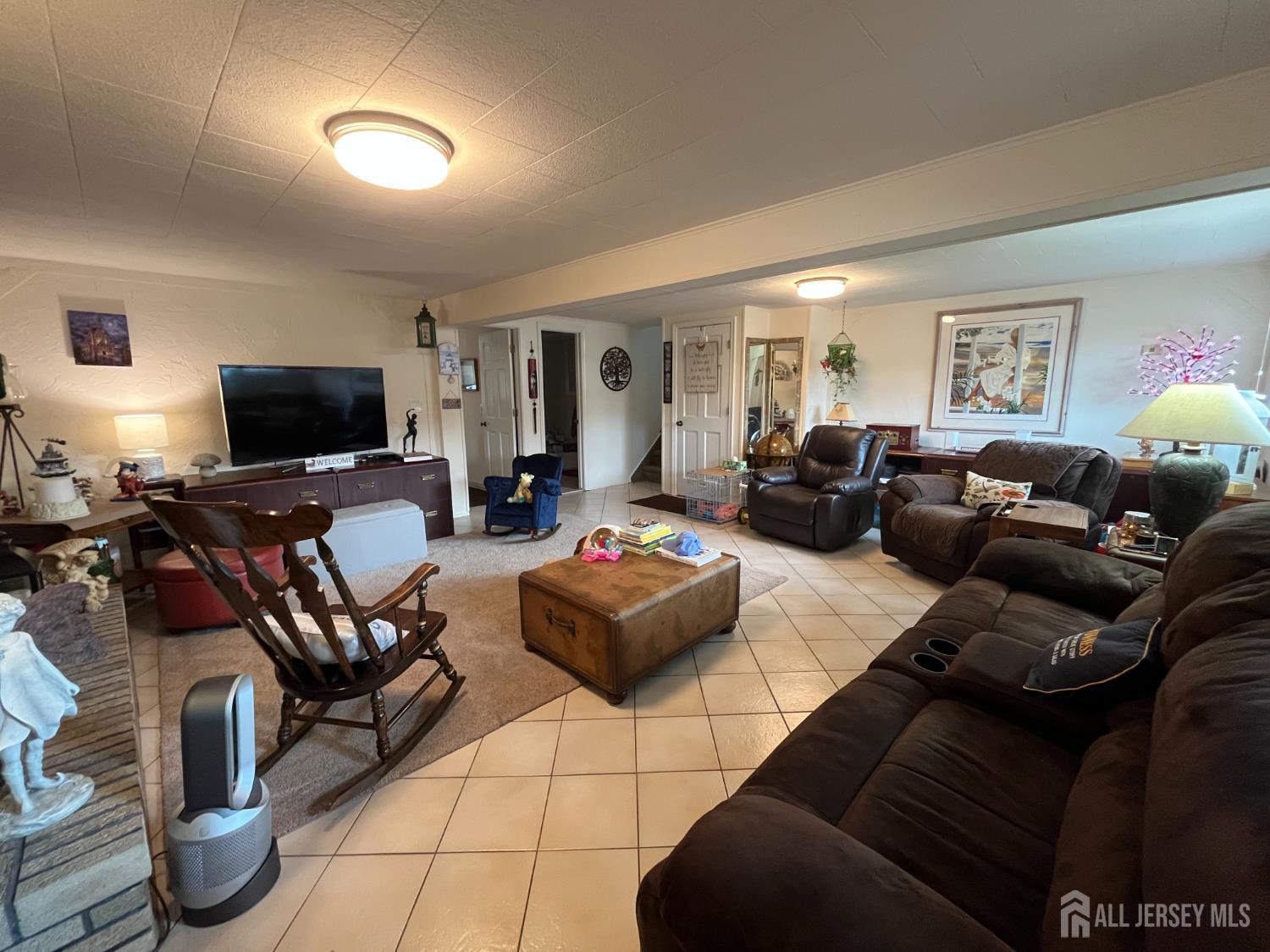 266 Amherst Avenue Colonia, NJ 07067 - Photo 12 of 22 a living room with furniture and a flat screen tv