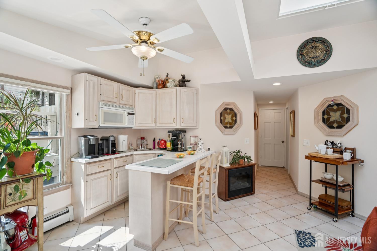 266 Amherst Avenue Colonia, NJ 07067 - Photo 14 of 22 a kitchen with a cabinets a dining table and chairs