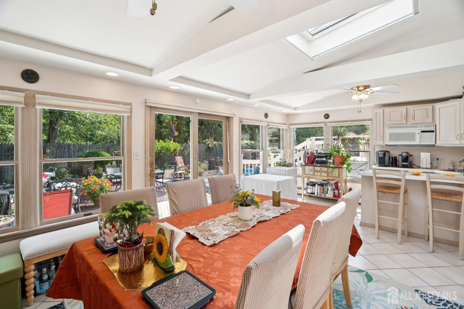 266 Amherst Avenue Colonia, NJ 07067 - Photo 18 of 22 a outdoor dining space with furniture a chandelier and a view of kitchen