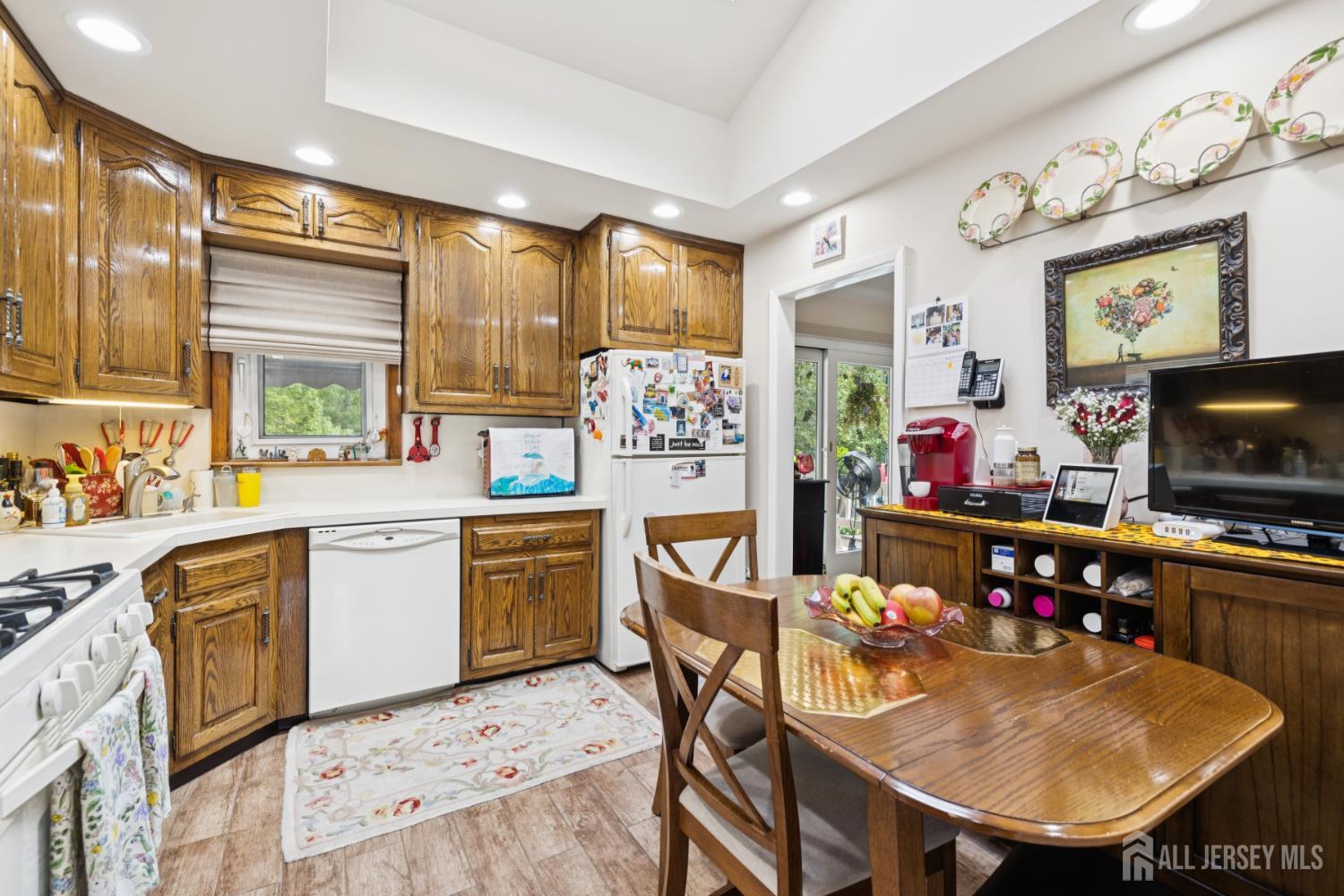 266 Amherst Avenue Colonia, NJ 07067 - Photo 5 of 22 a kitchen with stainless steel appliances kitchen island granite countertop a sink and cabinets