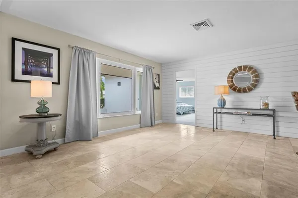a bedroom with a bed and a table chair