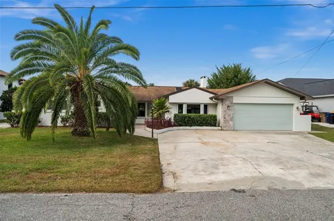 a large kitchen with stainless steel appliances granite countertop a stove oven and a sink