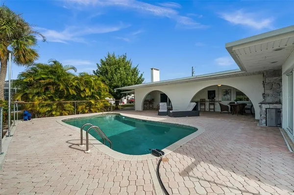 a view of a house with backyard and sitting area