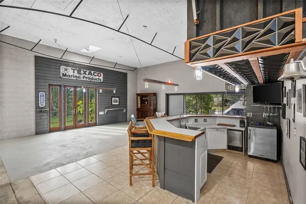 a kitchen with a sink a stove and chairs