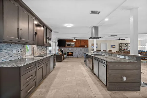 a large kitchen with stainless steel appliances lots of counter top space