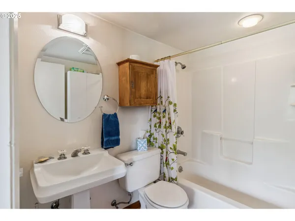 a bathroom with a sink toilet and a mirror