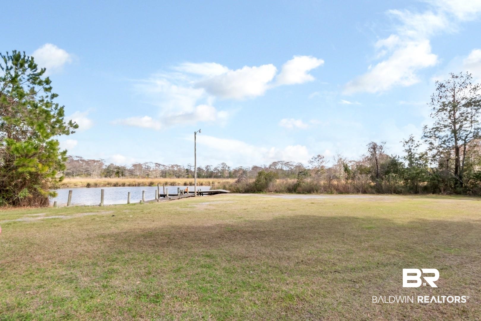 11528 Mocking Bird Lane Fairhope, AL 36532 - Photo 37 of 45 View of grassy yard with a boat dock and a water view