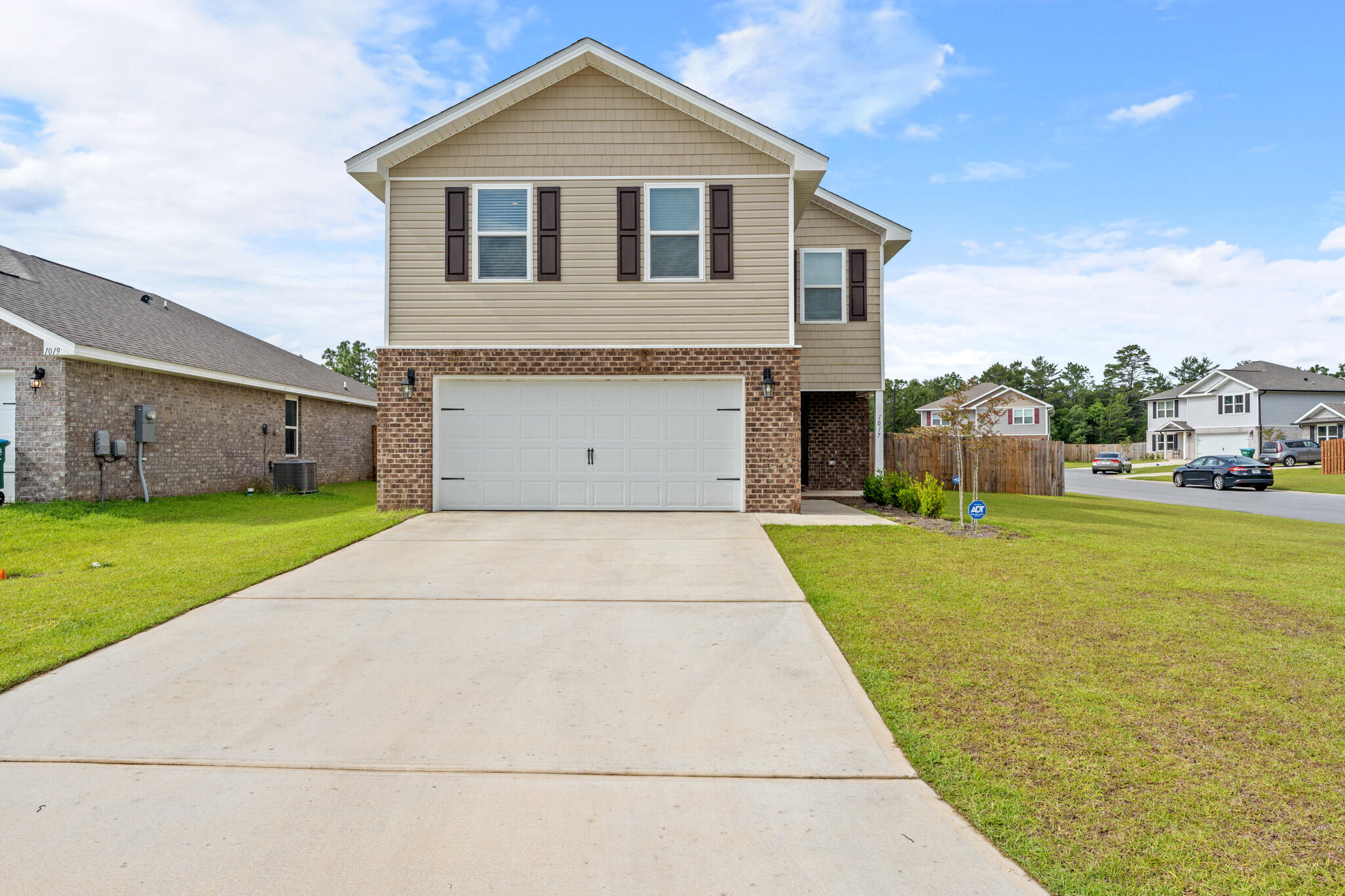 a front view of house with yard and garage
