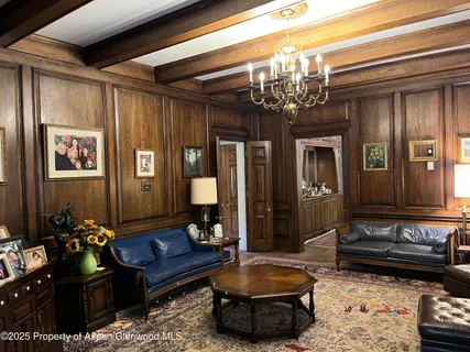a living room with furniture and a chandelier