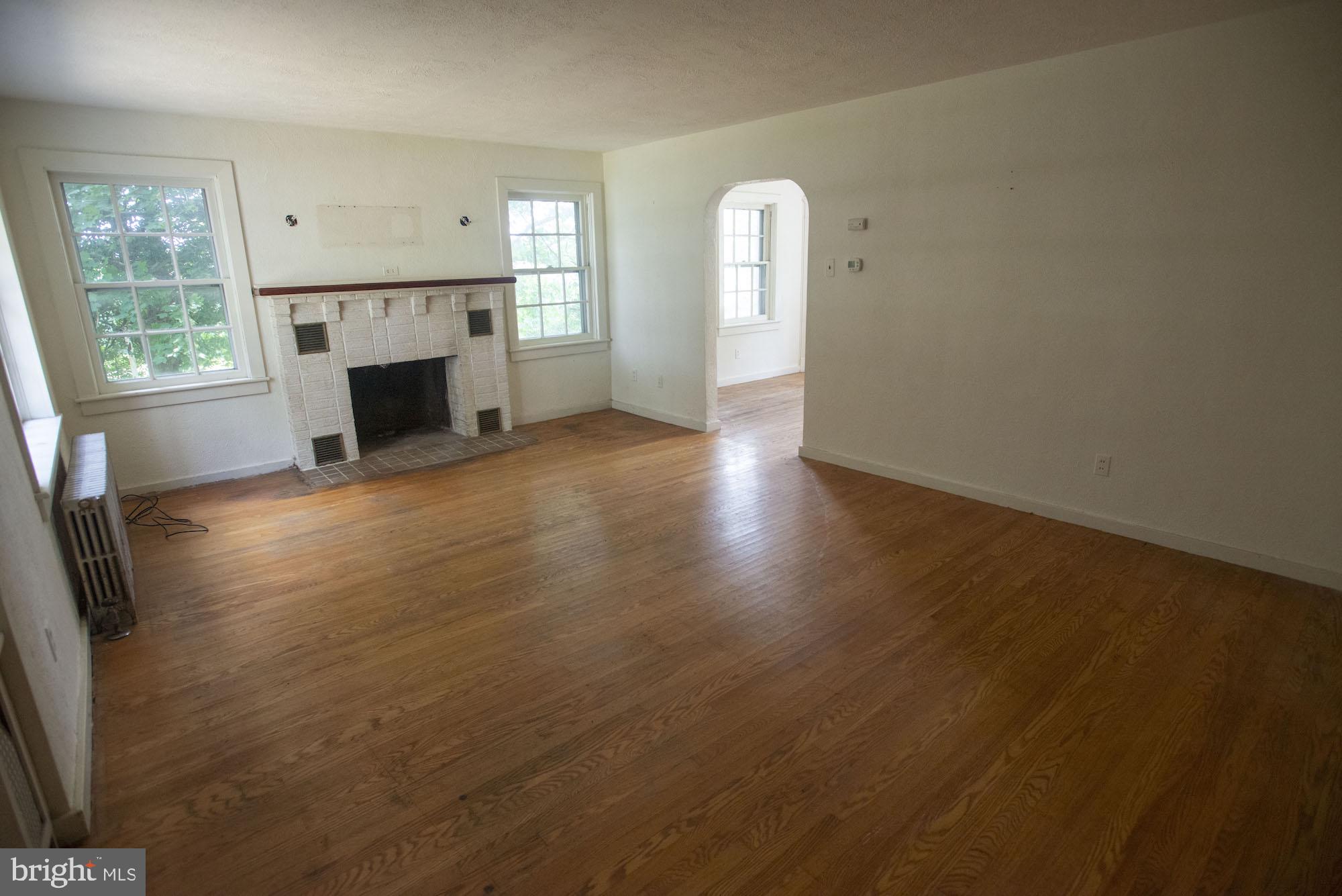 874-884 Delta Road Red Lion, PA 17356 - Photo 13 of 27 an empty room with windows a fireplace and wooden floor
