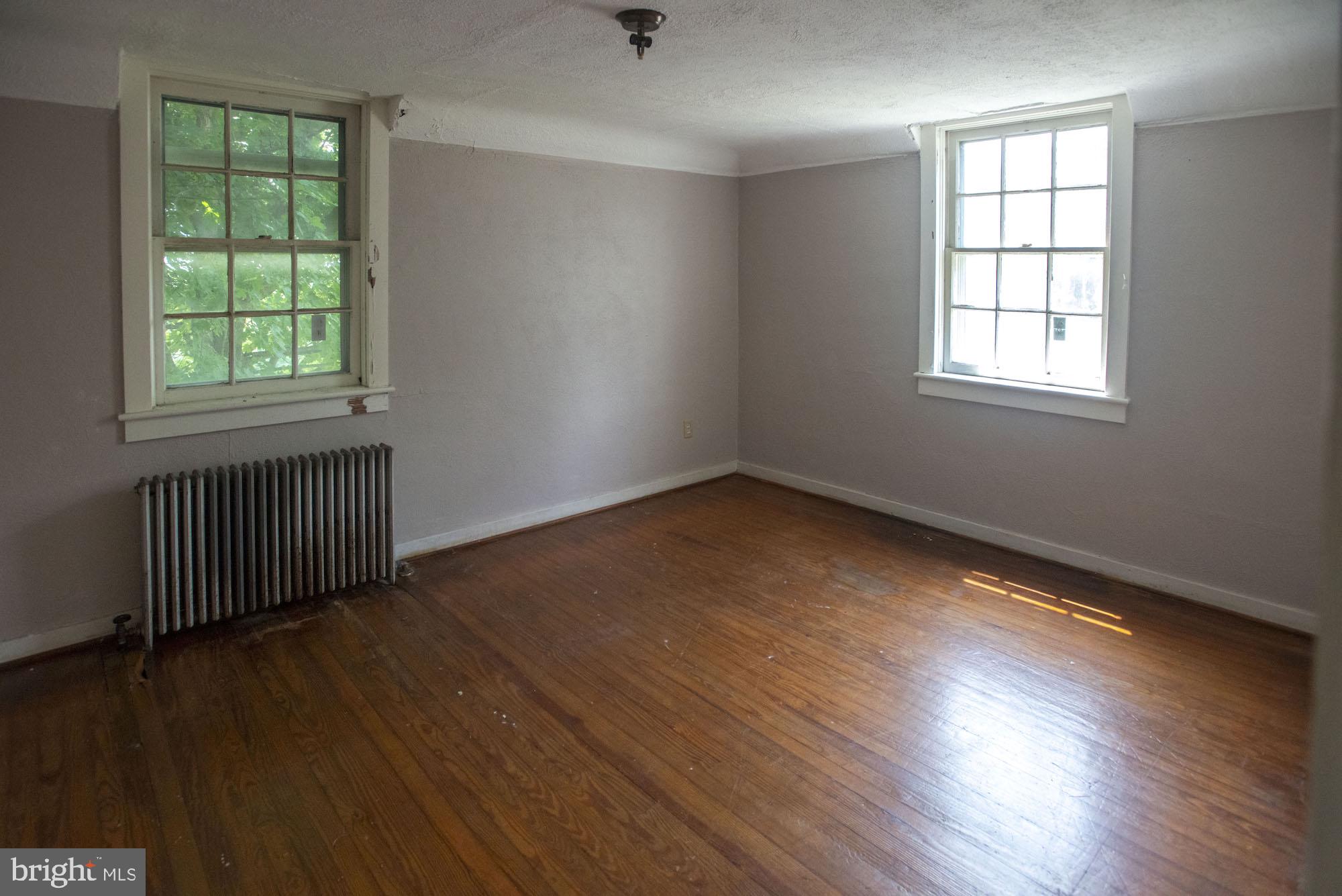 874-884 Delta Road Red Lion, PA 17356 - Photo 15 of 27 an empty room with wooden floor and windows