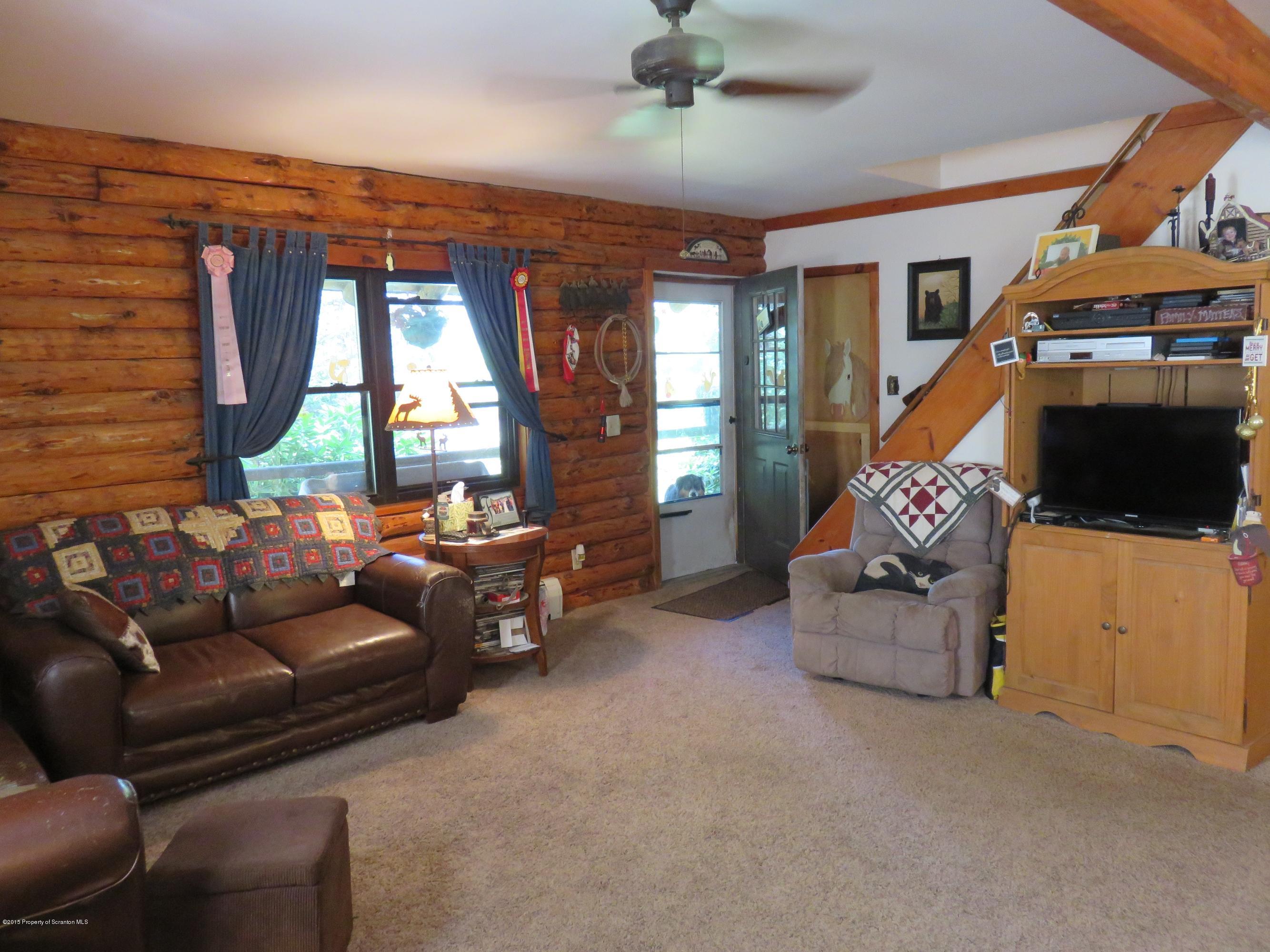 138 Spring Hill Road Moscow, PA 18444 - Photo 4 of 30 a living room with furniture and a flat screen tv