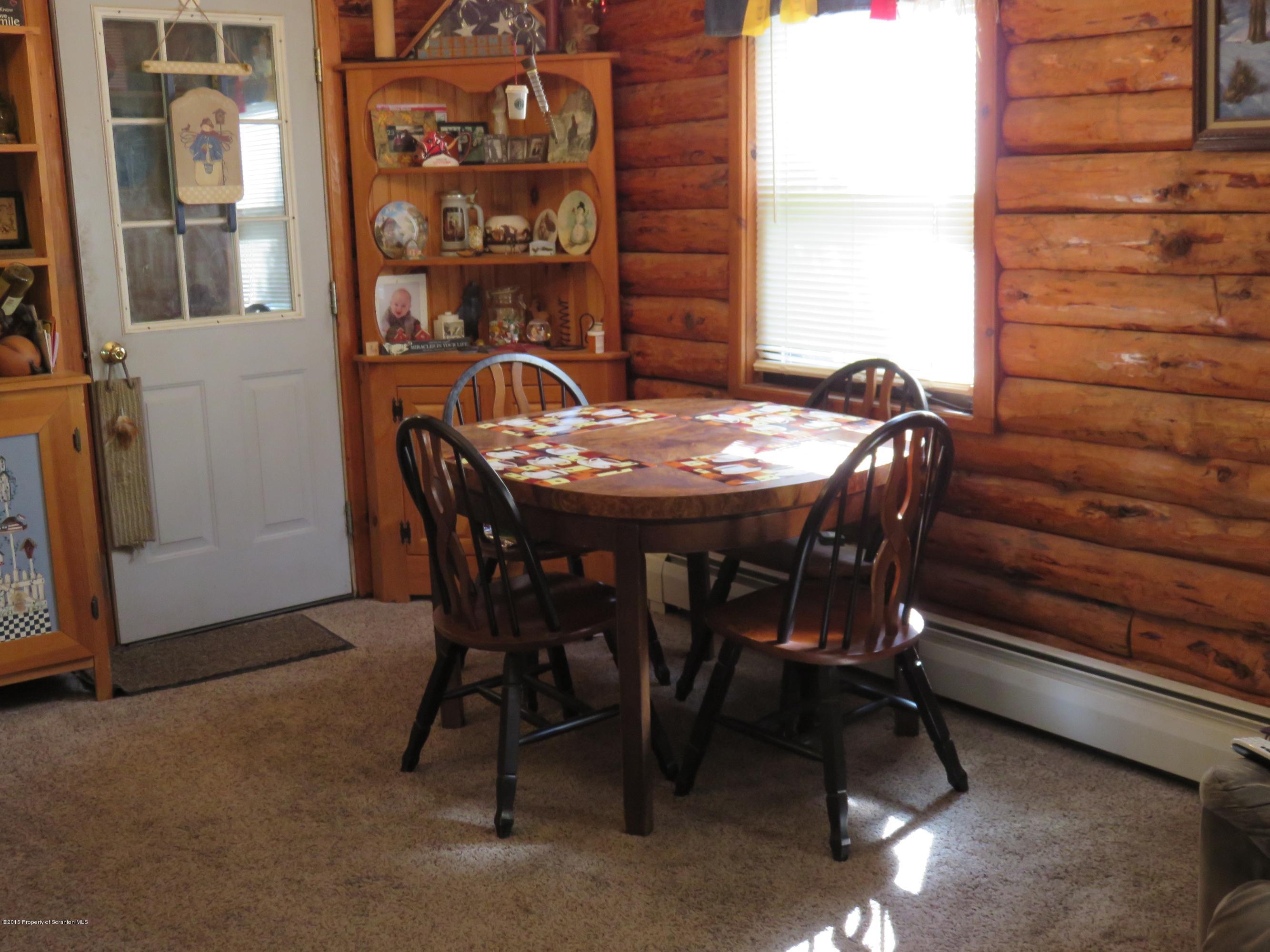 138 Spring Hill Road Moscow, PA 18444 - Photo 6 of 30 a view of a dining room with furniture and chandelier
