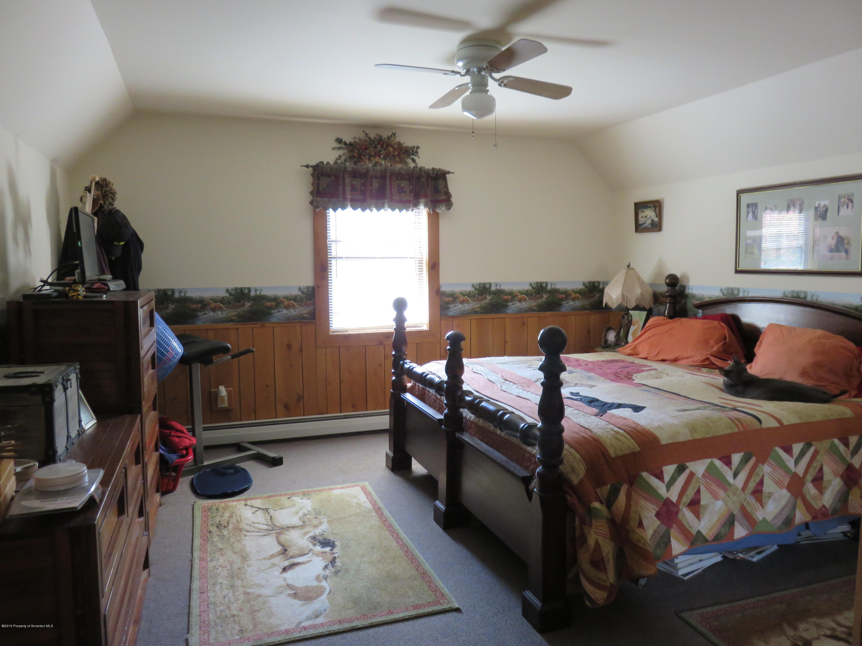 138 Spring Hill Road Moscow, PA 18444 - Photo 7 of 30 a bed room with a bed and a chandelier