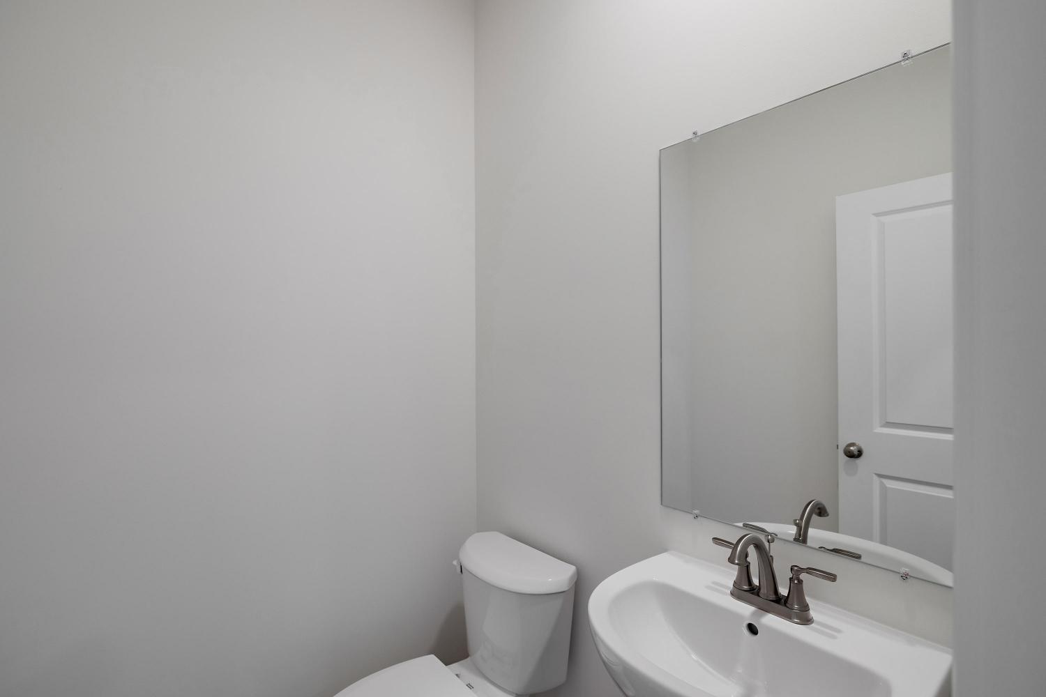 557 East 130th Lane Crown Point, IN 46307 - Photo 13 of 23 a bathroom with a toilet sink and mirror