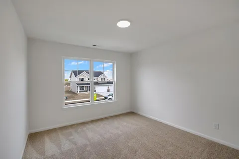 an empty room with windows and air conditioner
