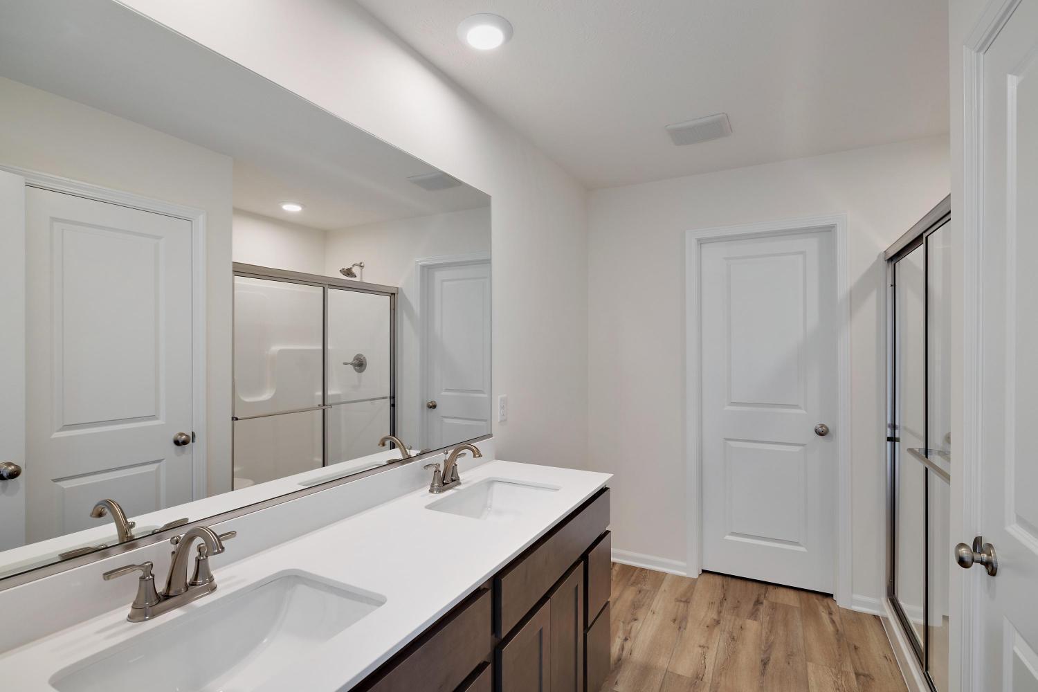 557 East 130th Lane Crown Point, IN 46307 - Photo 22 of 23 a bathroom with a sink double vanity granite tub shower and a mirror