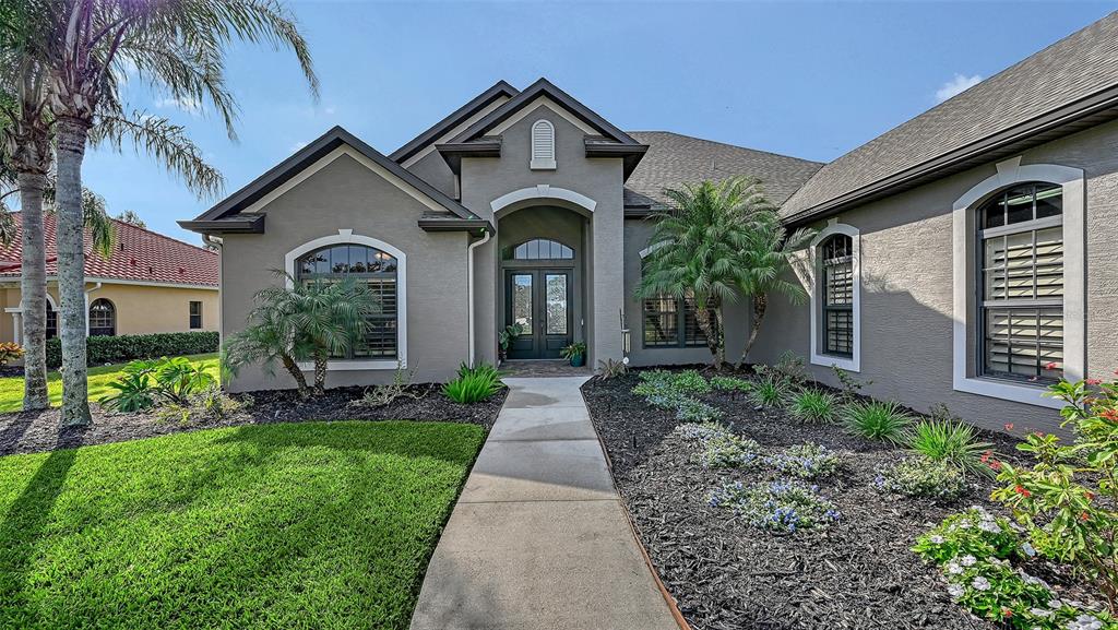 15425 Mulholland Road Parrish, FL 34219 - Photo 13 of 67 a front view of a house with garden