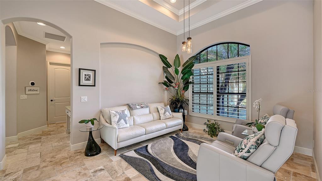 15425 Mulholland Road Parrish, FL 34219 - Photo 17 of 67 a living room with furniture a rug and a potted plant