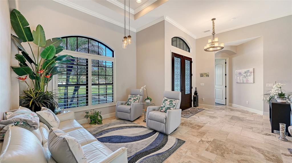 15425 Mulholland Road Parrish, FL 34219 - Photo 18 of 67 a living room with furniture flower pot and a chandelier
