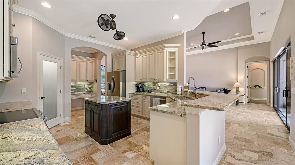 15425 Mulholland Road Parrish, FL 34219 - Photo 25 of 67 a kitchen with a stove a refrigerator and a sink