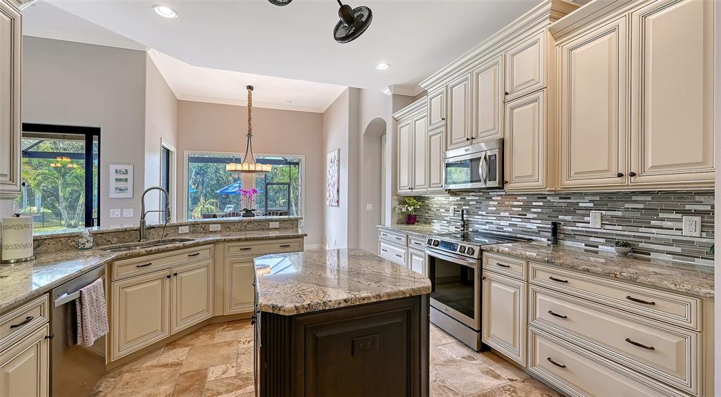15425 Mulholland Road Parrish, FL 34219 - Photo 26 of 67 a kitchen with stainless steel appliances granite countertop a sink stove and cabinets